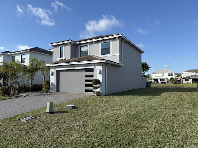 front facade featuring a front lawn and a garage