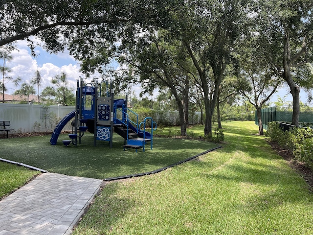 view of jungle gym featuring a lawn