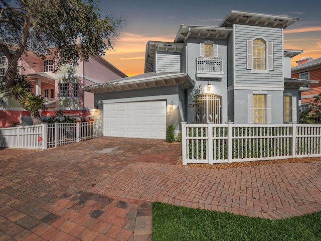 view of front of house featuring a garage and a balcony