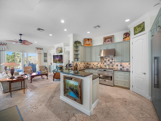 kitchen featuring tasteful backsplash, dark stone countertops, high quality appliances, kitchen peninsula, and green cabinets