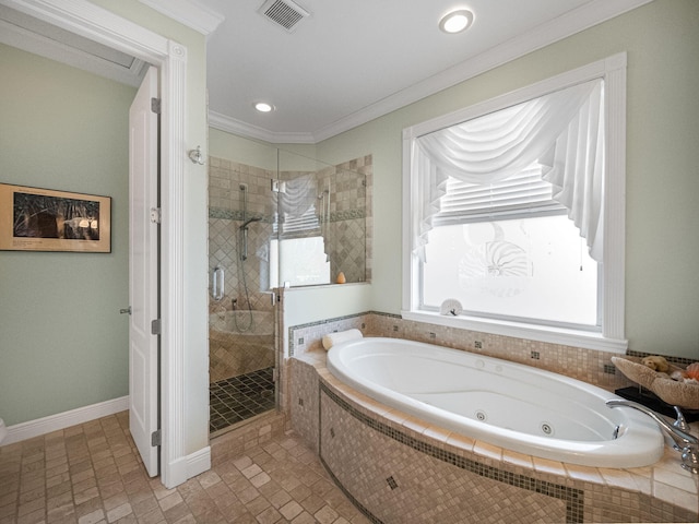 bathroom featuring ornamental molding and shower with separate bathtub