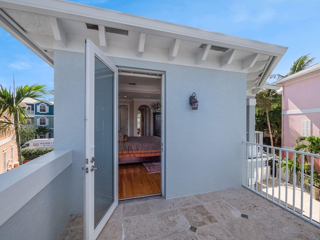 view of exterior entry featuring a balcony