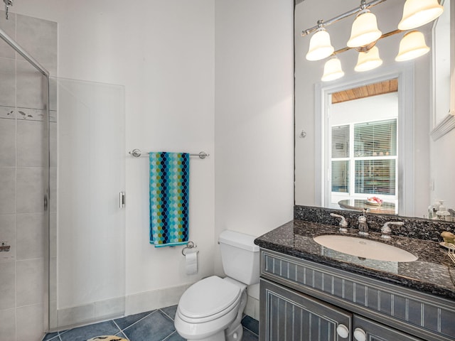 bathroom with vanity, a shower with shower door, tile patterned floors, and toilet