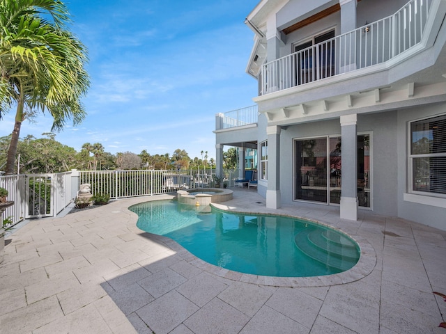 view of swimming pool featuring an in ground hot tub and a patio