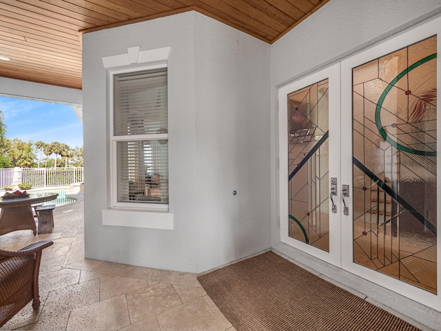 property entrance with a patio area and french doors