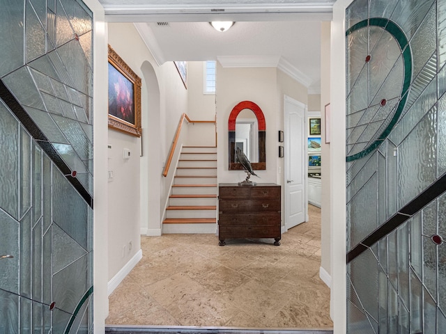 foyer entrance featuring ornamental molding