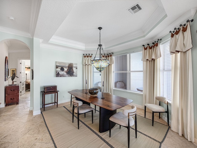 dining room featuring crown molding, a tray ceiling, and a textured ceiling