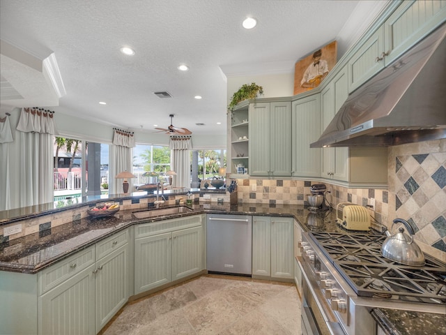 kitchen with dark stone countertops, sink, tasteful backsplash, and appliances with stainless steel finishes