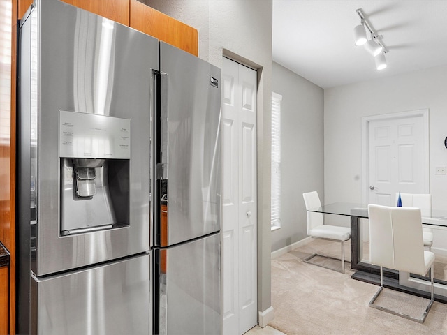 kitchen with light colored carpet and stainless steel refrigerator with ice dispenser