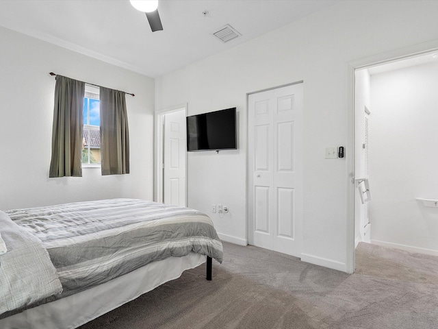 bedroom with ceiling fan and light carpet