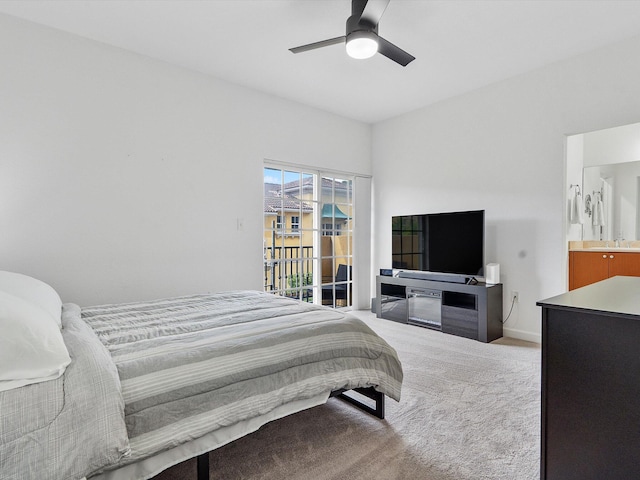 bedroom featuring ensuite bathroom, ceiling fan, and light colored carpet