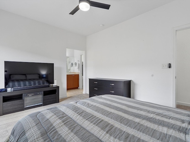 carpeted bedroom with ceiling fan and ensuite bathroom