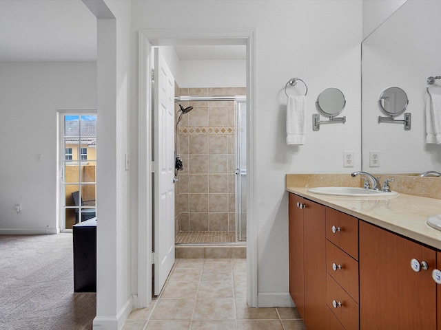 bathroom with tile patterned floors, vanity, and an enclosed shower