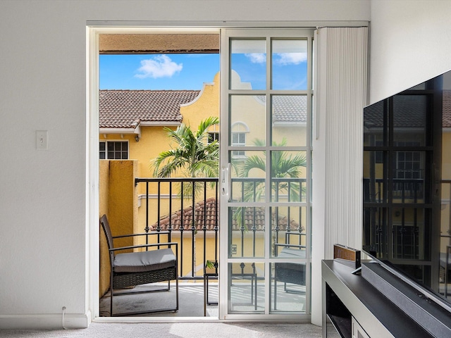 doorway featuring carpet flooring