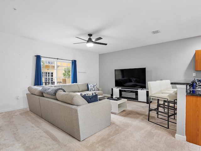 carpeted living room featuring ceiling fan