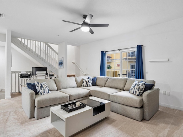 carpeted living room featuring ceiling fan