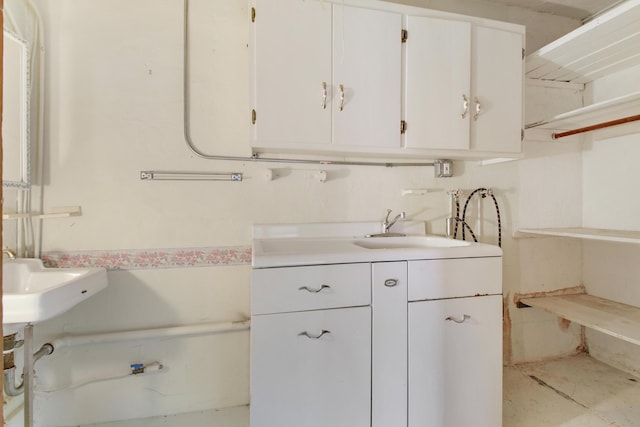 interior space with hookup for a washing machine, sink, and cabinets