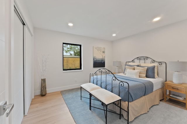 bedroom featuring a closet and light hardwood / wood-style flooring