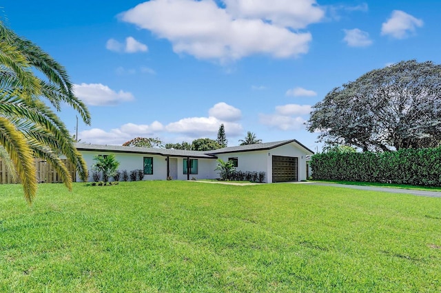 ranch-style home with a garage and a front lawn