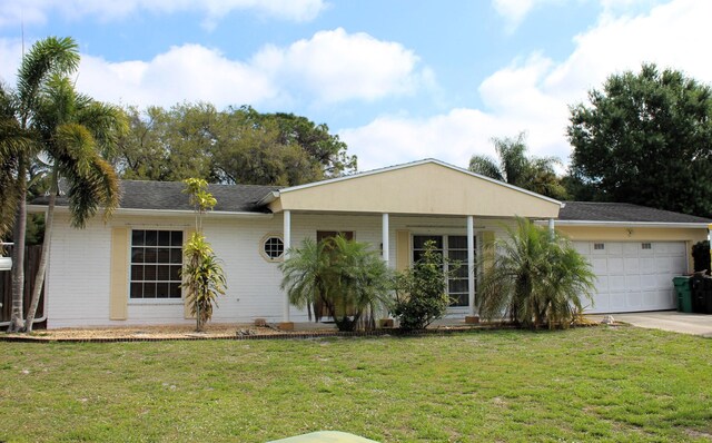 ranch-style home featuring a front yard and a garage