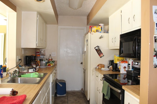 kitchen with black microwave, light countertops, a sink, and stainless steel electric stove