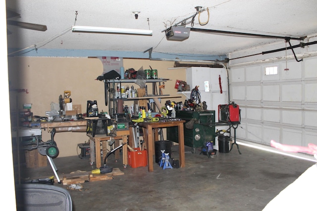 garage with a garage door opener and a workshop area