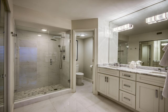 bathroom featuring vanity, toilet, and a shower with door