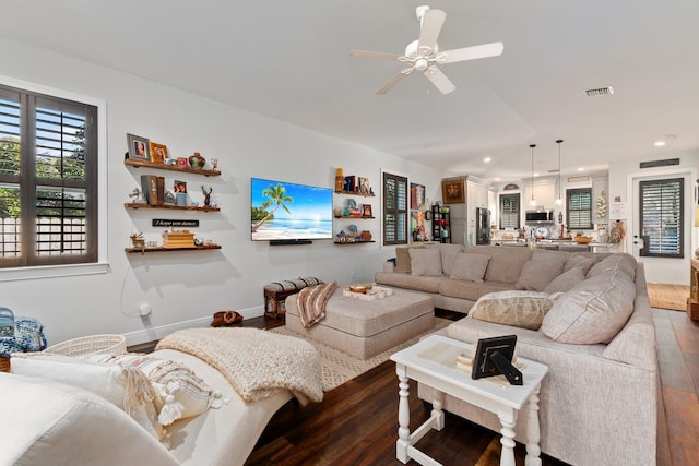 living room featuring ceiling fan and wood-type flooring