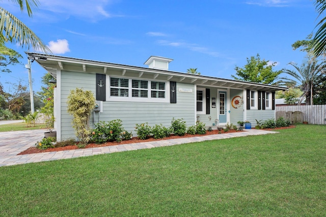 ranch-style house featuring a porch and a front lawn