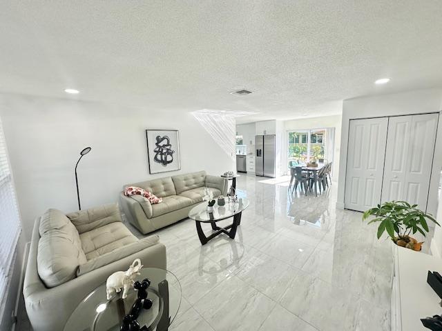 living room featuring a textured ceiling