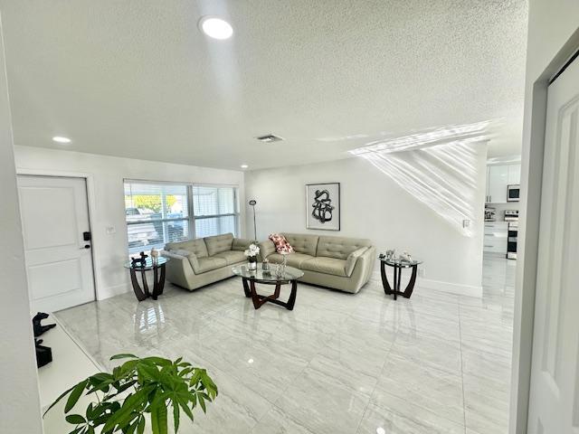 living room featuring a textured ceiling