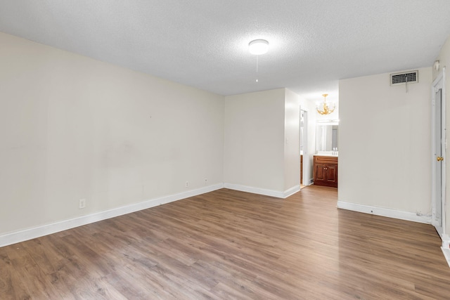 interior space featuring a chandelier, hardwood / wood-style floors, and a textured ceiling