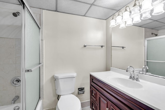 full bathroom featuring vanity, toilet, and bath / shower combo with glass door