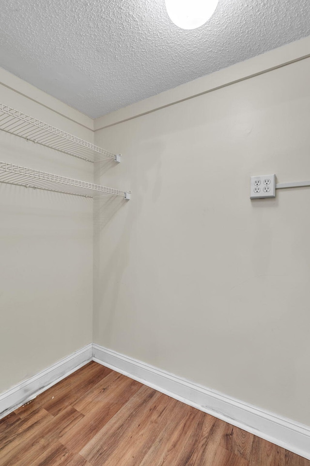 walk in closet featuring hardwood / wood-style flooring