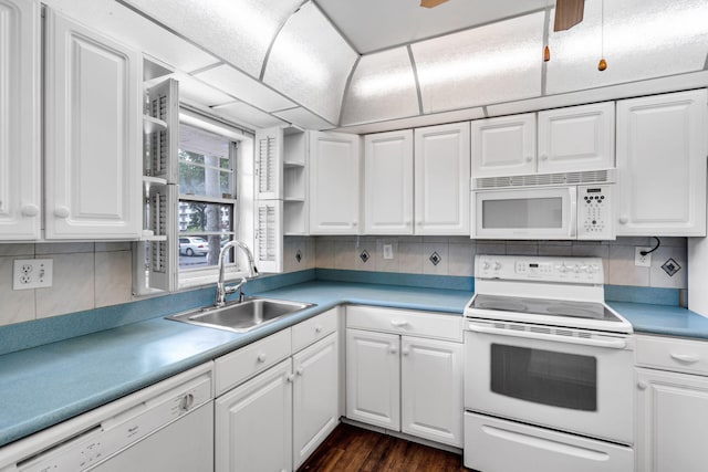 kitchen with white cabinets, white appliances, backsplash, and sink