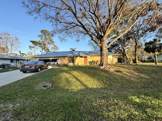 single story home featuring a front lawn and a carport