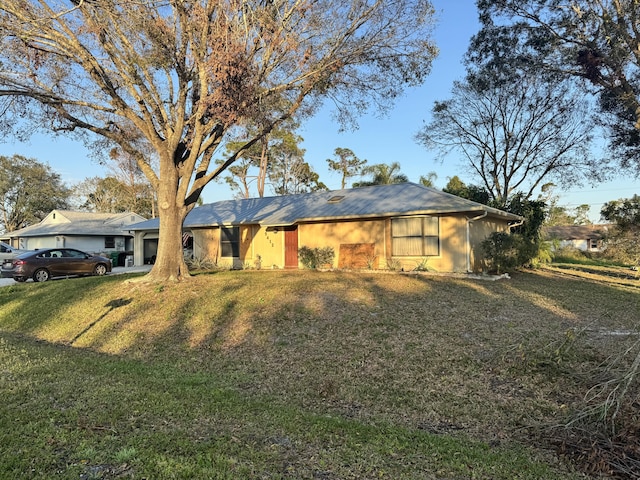 ranch-style home featuring a front yard