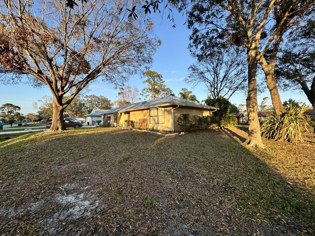 view of home's exterior with a lawn