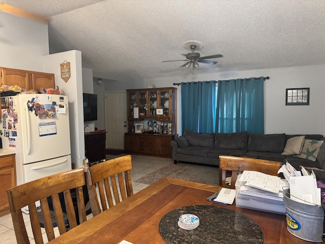 living room with lofted ceiling, ceiling fan, and a textured ceiling