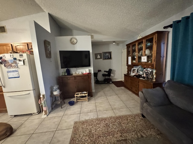 tiled living room featuring a textured ceiling