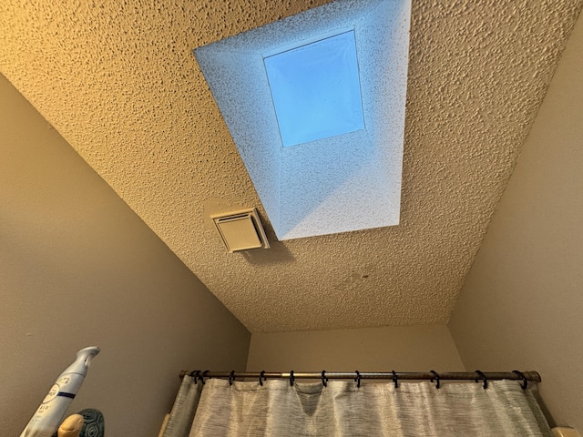 interior details featuring a textured ceiling