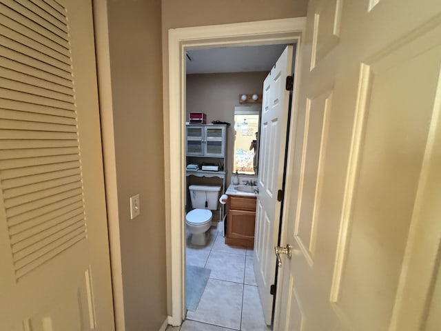 bathroom with tile patterned floors, vanity, and toilet