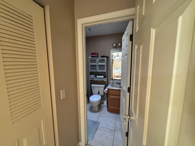 bathroom with tile patterned flooring, vanity, and toilet