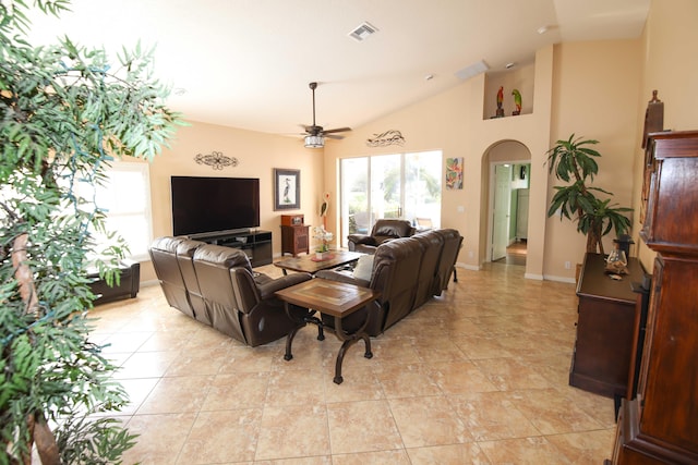 living room with ceiling fan, light tile patterned flooring, and lofted ceiling