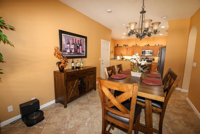 dining room with an inviting chandelier and light tile patterned floors