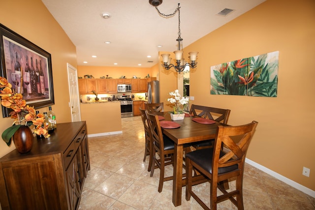 tiled dining room with an inviting chandelier