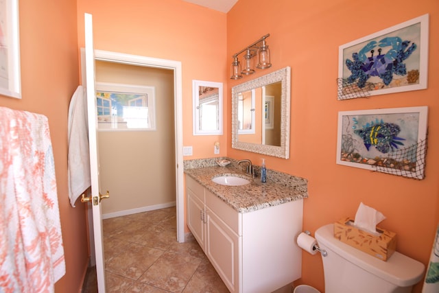 bathroom featuring toilet, tile patterned flooring, and vanity