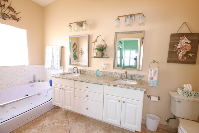 bathroom featuring toilet, a washtub, tile patterned flooring, and vanity