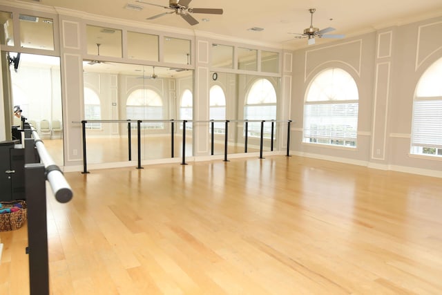 interior space with ornamental molding, ceiling fan, and light hardwood / wood-style floors