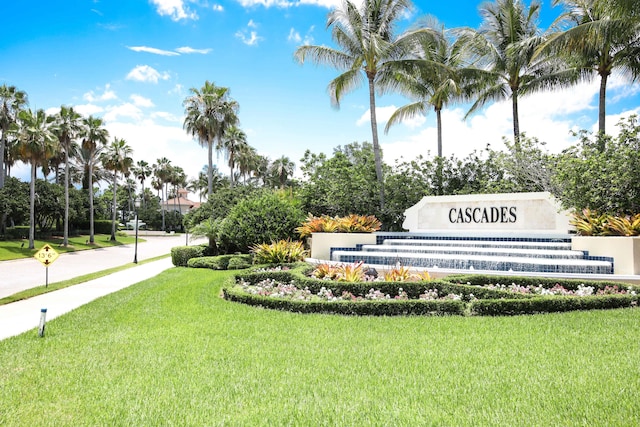 community sign featuring a lawn